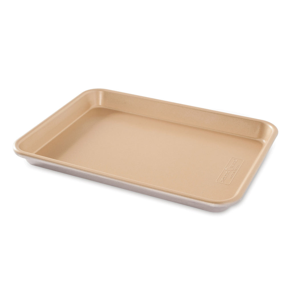 Empty nonstick quarter sheet pan, rectangular tray with corners in light beige