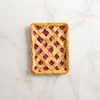 Nonstick quarter sheet baking pan holding lattice berry pastry