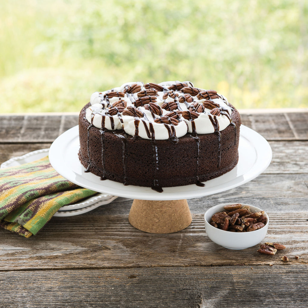 Nonstick round layer cake pan, shown with chocolate cake and white icing on plate