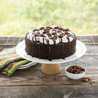 Nonstick round layer cake pan, shown with chocolate cake and white icing on plate