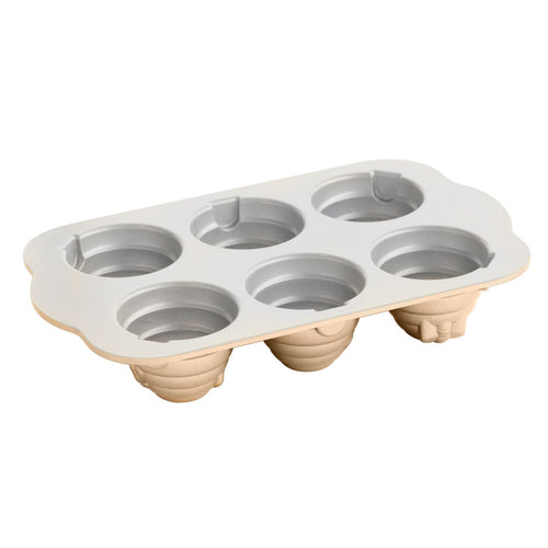 Beehive cakelet pan with seven wells and raised beehive cone cavity shapes