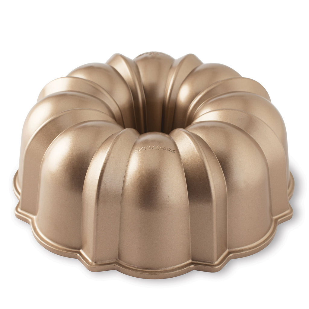 Bronze-gold bundt pan with ridged fluted ring mold and side handles