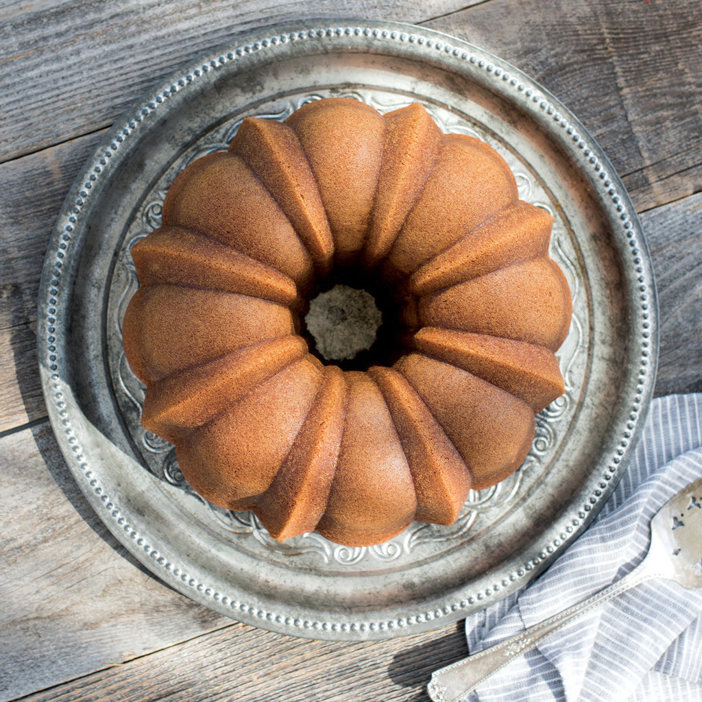Bundt pan filled with golden-brown ring cake in fluted ridged mold