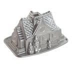 Silver metal gingerbread house bundt pan mold with detailed house design and base tray