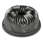 Black fluted Bundt pan with central tube and decorative ridges, round bakeware mold.