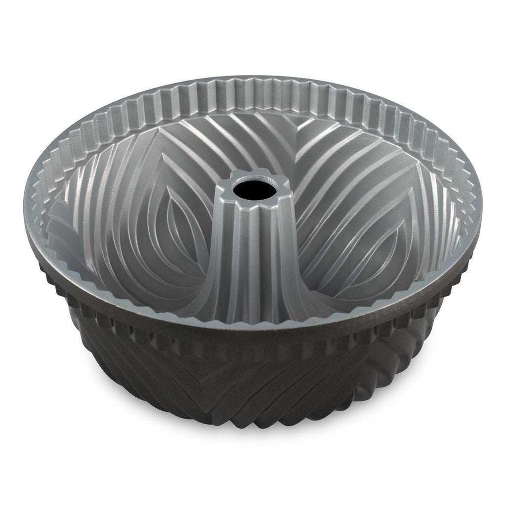 Gray fluted Bundt pan with central tube and ridged sides, round baking mold.