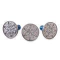 Snowflake cookie stamp set: three round metal discs with blue handles, front view