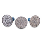 Snowflake cookie stamp set: three round metal discs with blue handles, front view