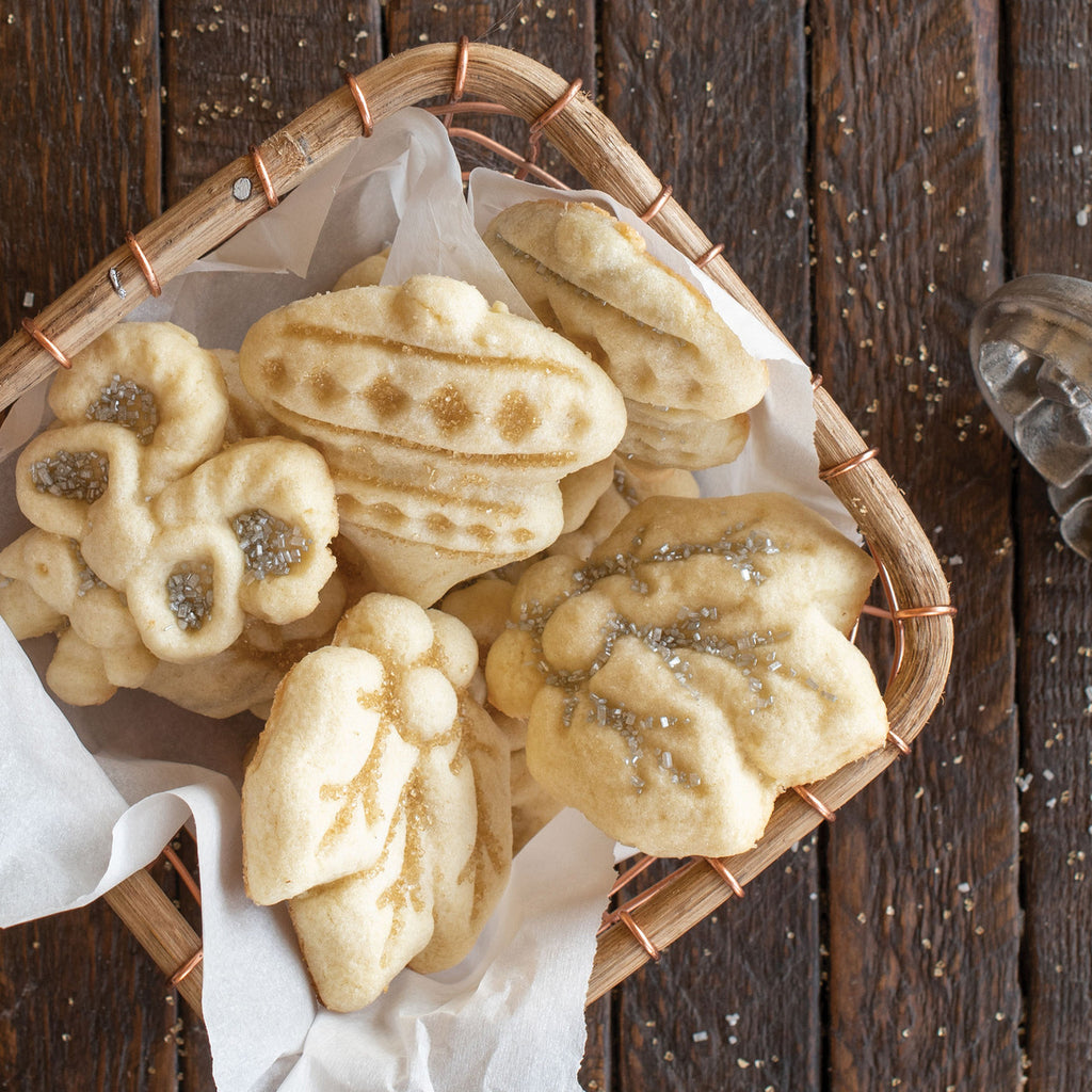 Basket of baked holiday cookies, stamped with embossed cut-out designs