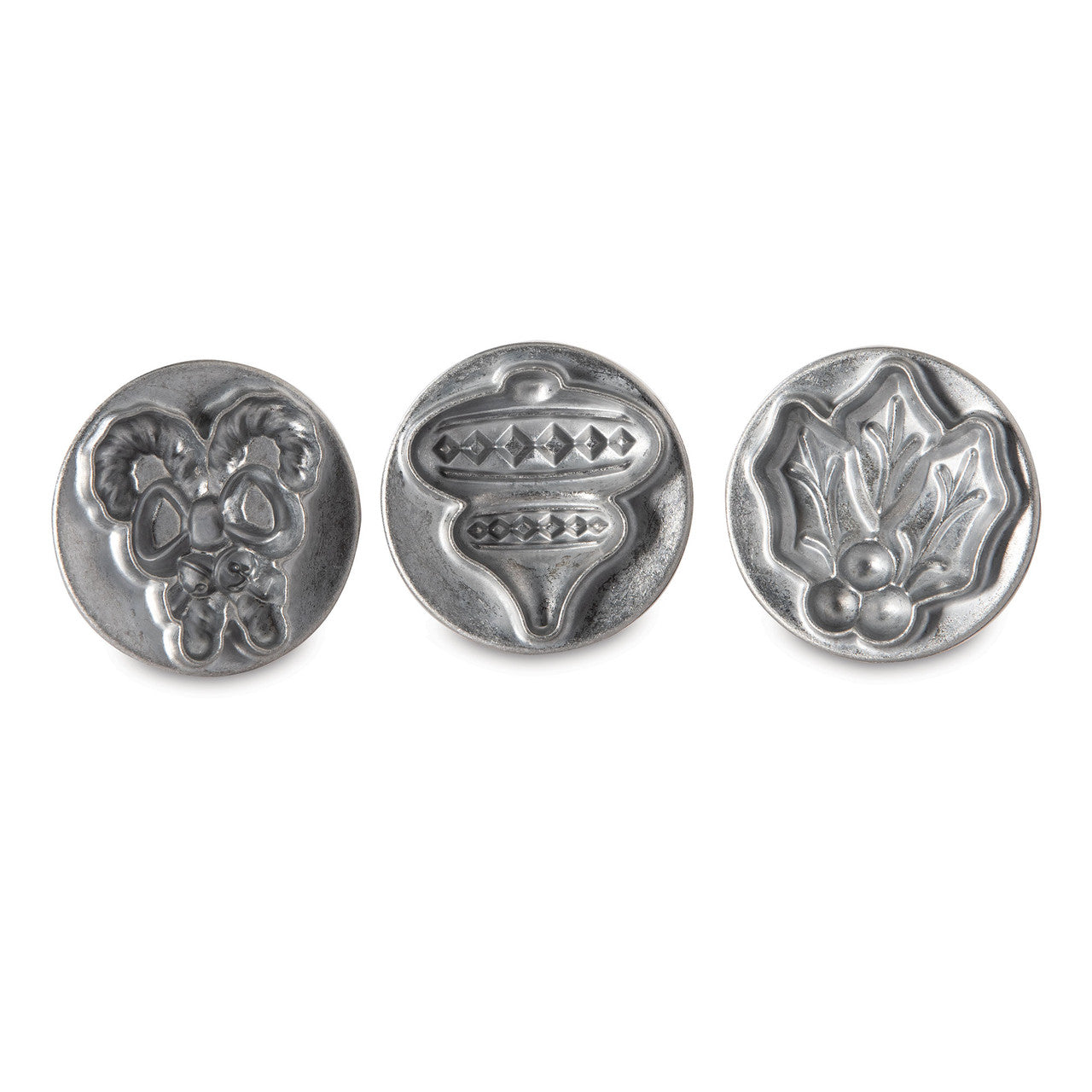 Three silver holiday cookie stamp molds featuring raised 3D patterns