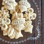 Sugar-dusted stamped holiday cookies with embossed shapes and details